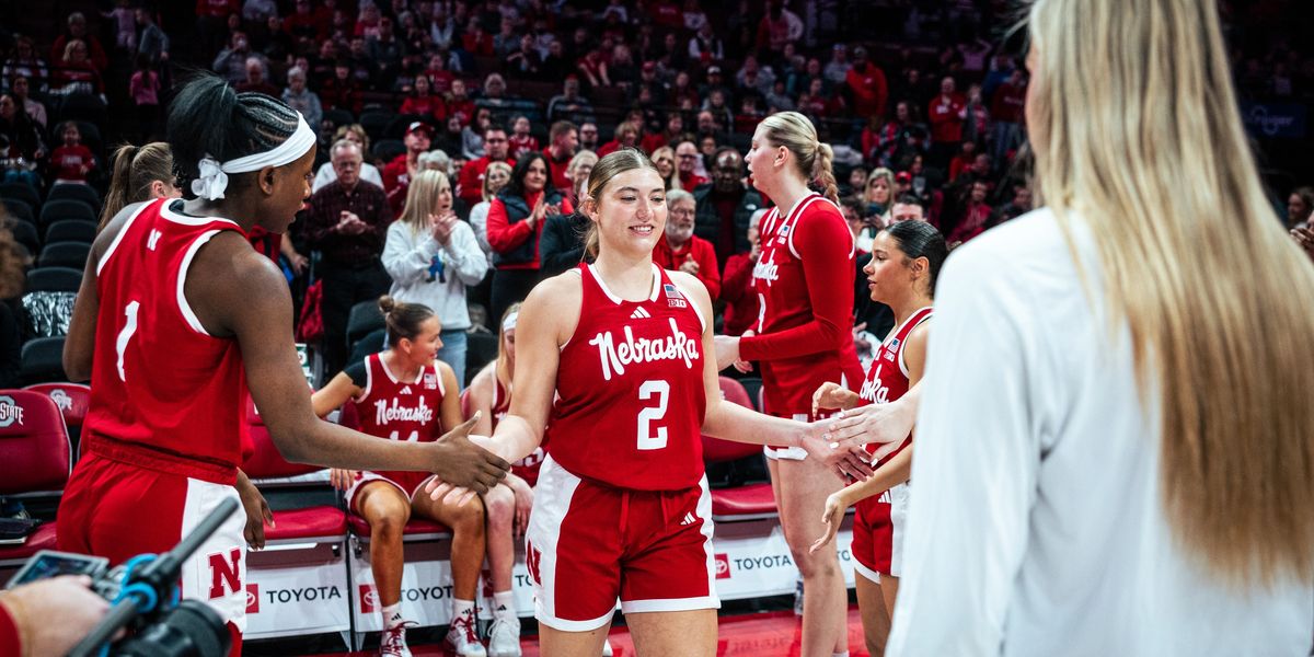Logan Nissley greeting teammates on the court